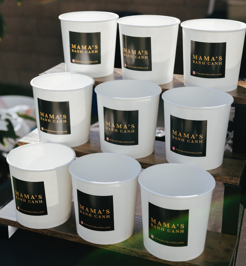 Catering display of stacked bowls with Mama's Banh Canh branding